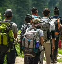 group of people with backpacks hiking
